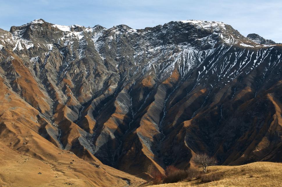 Free Image of Mountain landscape with snow-capped peaks and valleys. 
