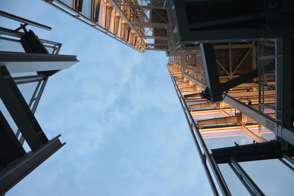 Free Image of Looking up at modern skyscrapers against blue sky. 