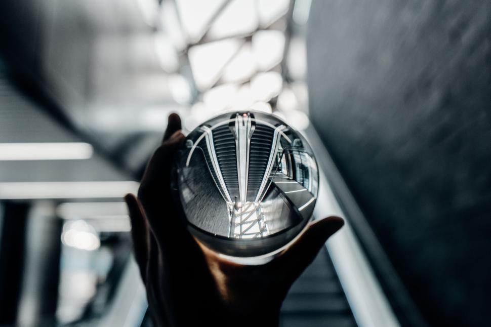 Free Image of Glass sphere reflecting an architectural interior. 