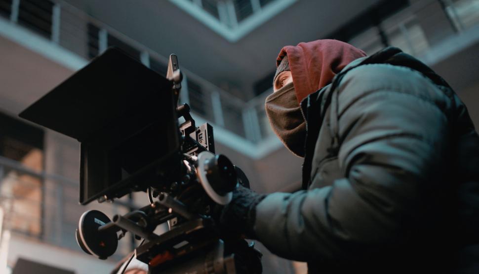 Free Image of Cameraman operating professional equipment outdoors 