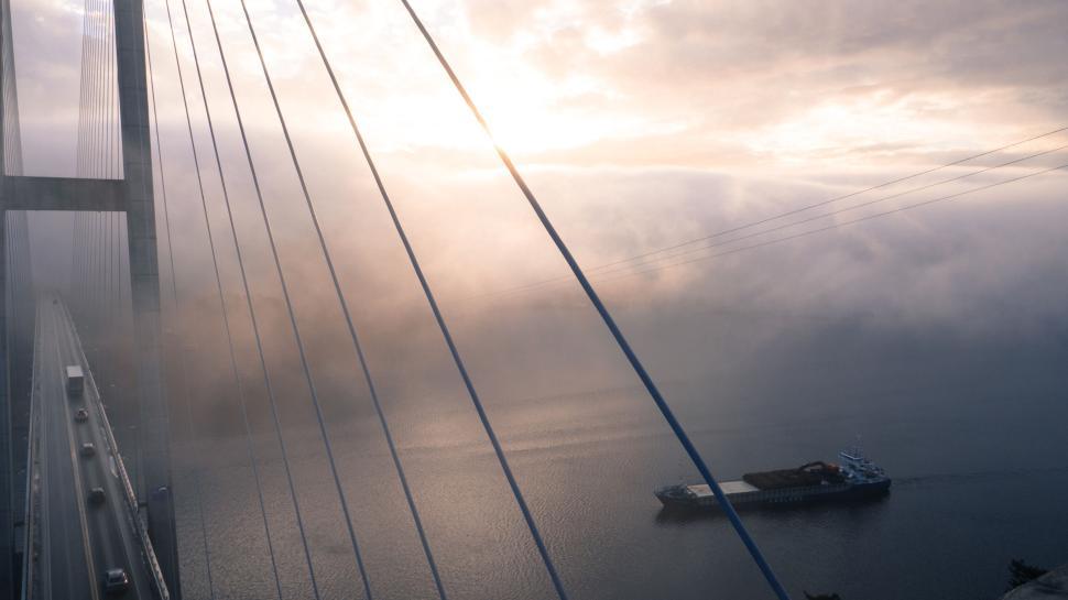 Free Image of Aerial view of bridge with ship in the water. 