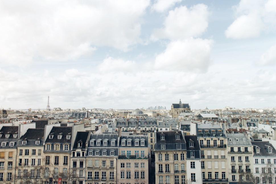 Free Image of Rooftop view of cityscape with sky and clouds above 