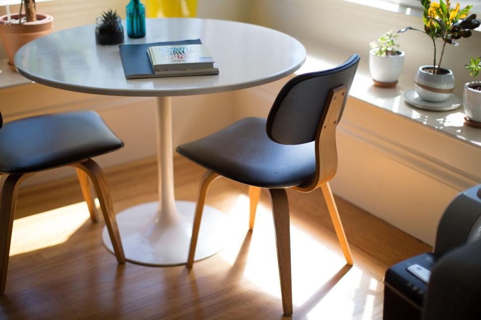 Free Image of Cozy dining area with sunlight and modern furniture 