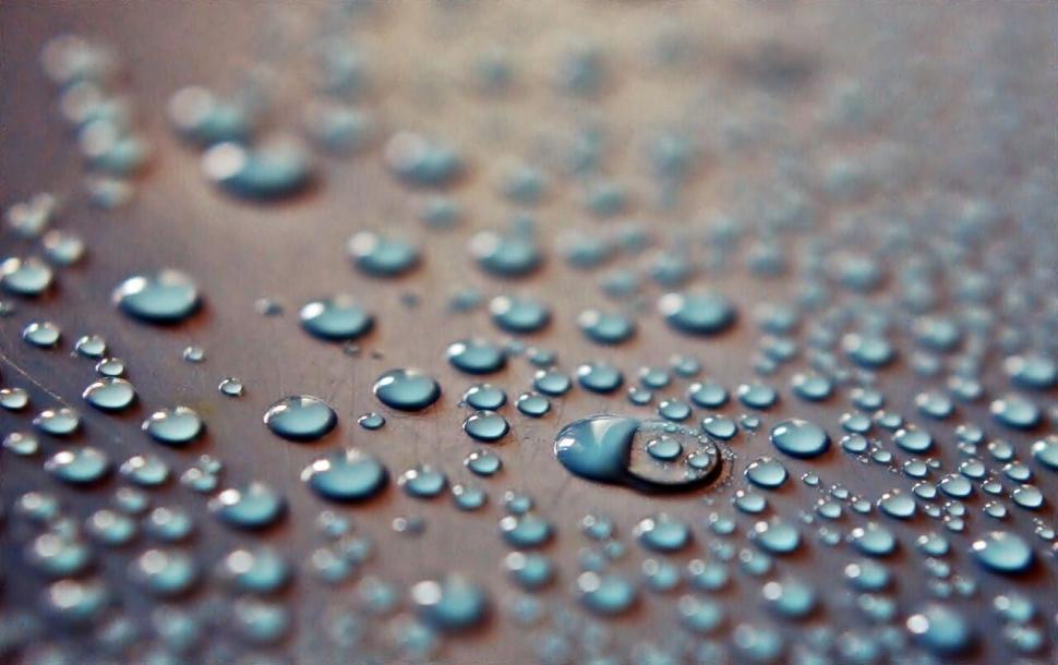 Free Image of Close-up of water droplets on a smooth surface, focused 