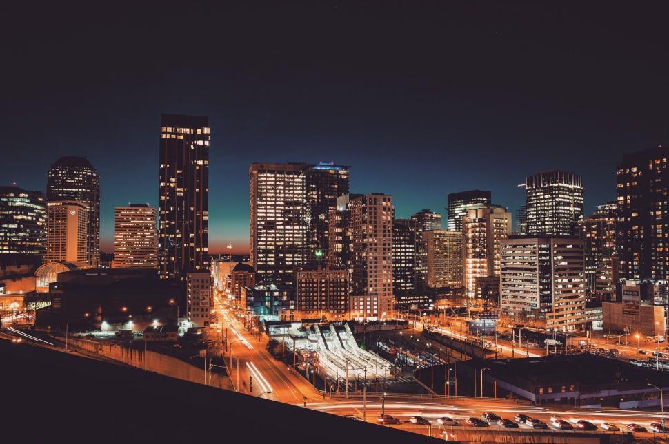 Free Image of Vibrant urban cityscape at night with illuminated buildings. 