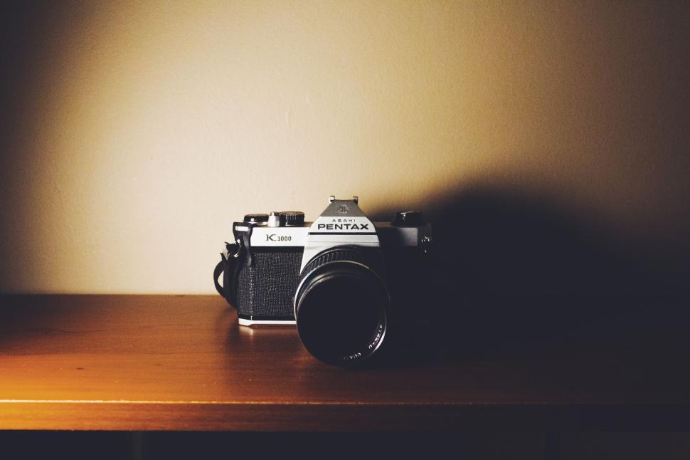 Free Image of Vintage Pentax camera displayed on a wooden shelf. 