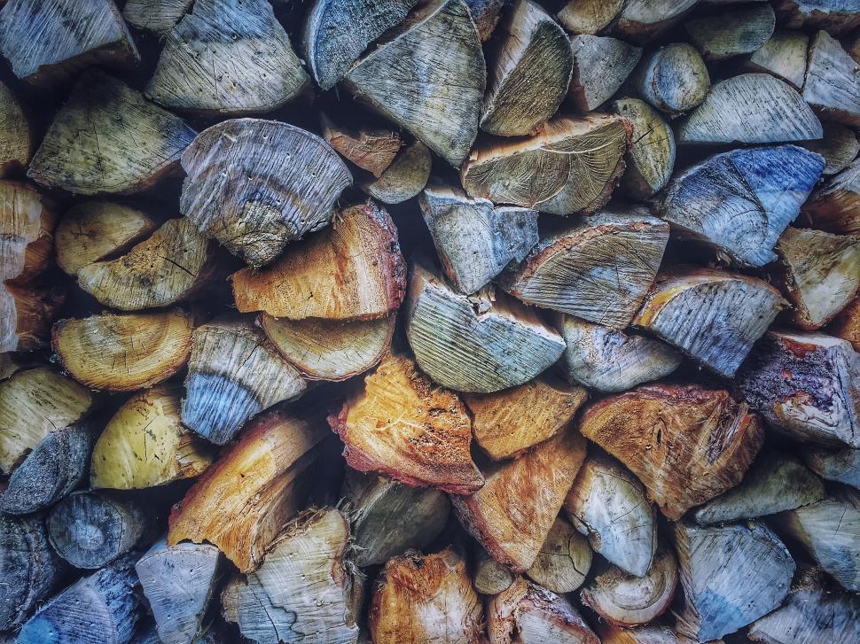 Free Image of Pile of chopped wooden logs stacked together in rows 