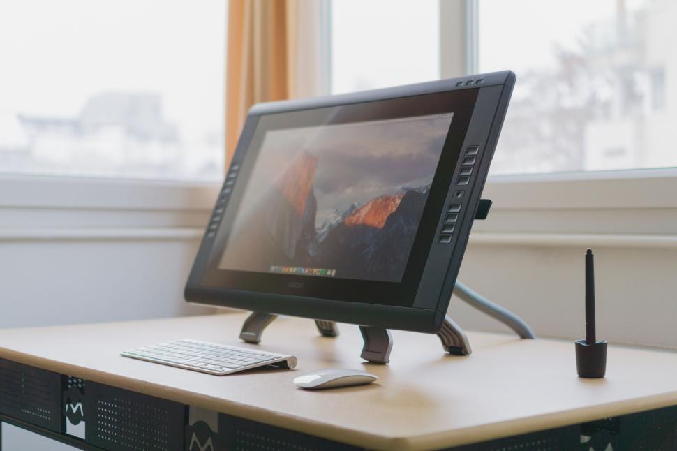 Free Image of Graphic design workspace with drawing tablet and stylus 