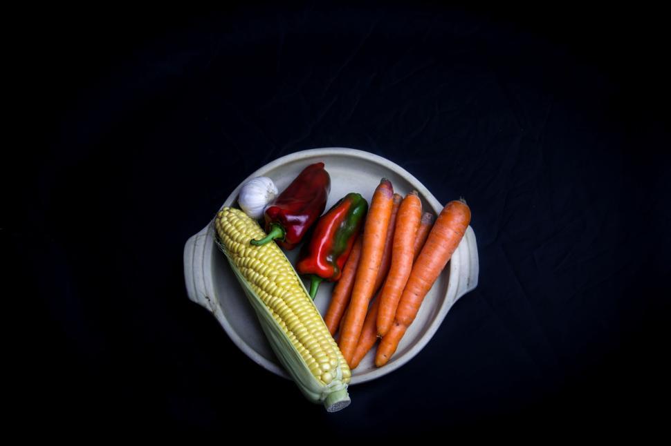 Free Image of Colorful vegetables in a bowl against black back. 