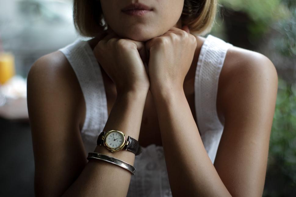 Free Image of Person with watch and bracelets resting on hands 