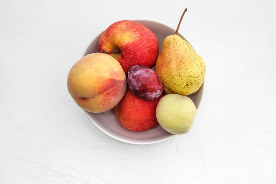Free Image of Fruit bowl with apples, peach, pear, plum, and apricot 