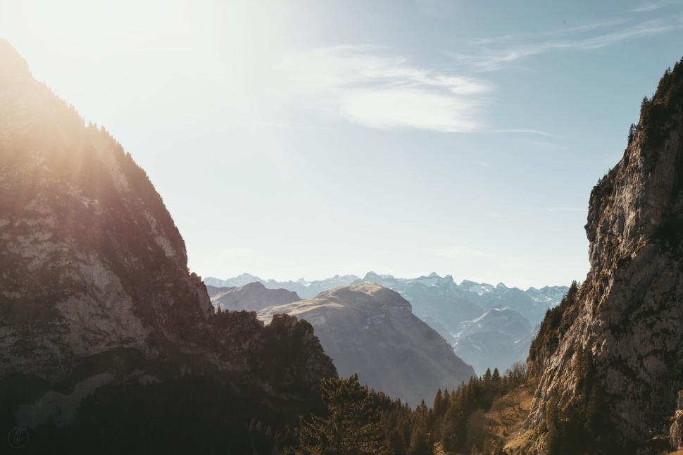 Free Image of Sunlit mountain landscape with distant mountain ranges. 