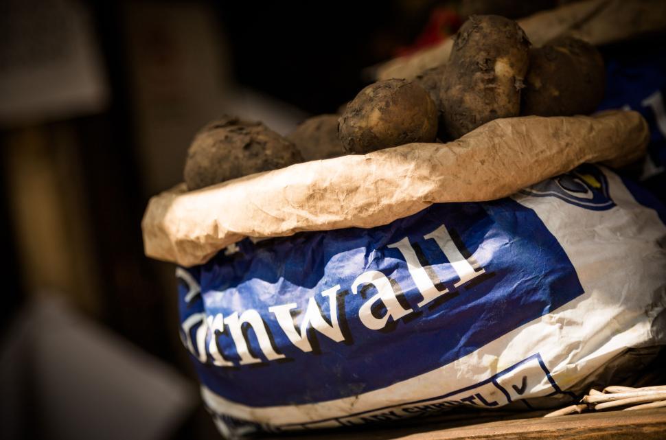 Free Image of Close-up of potatoes in paper bag with Cornwall label. 