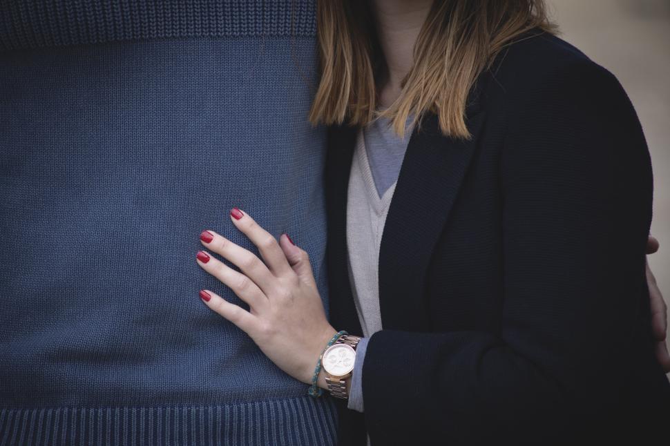 Free Image of Closeup of woman embracing person in blue sweater 