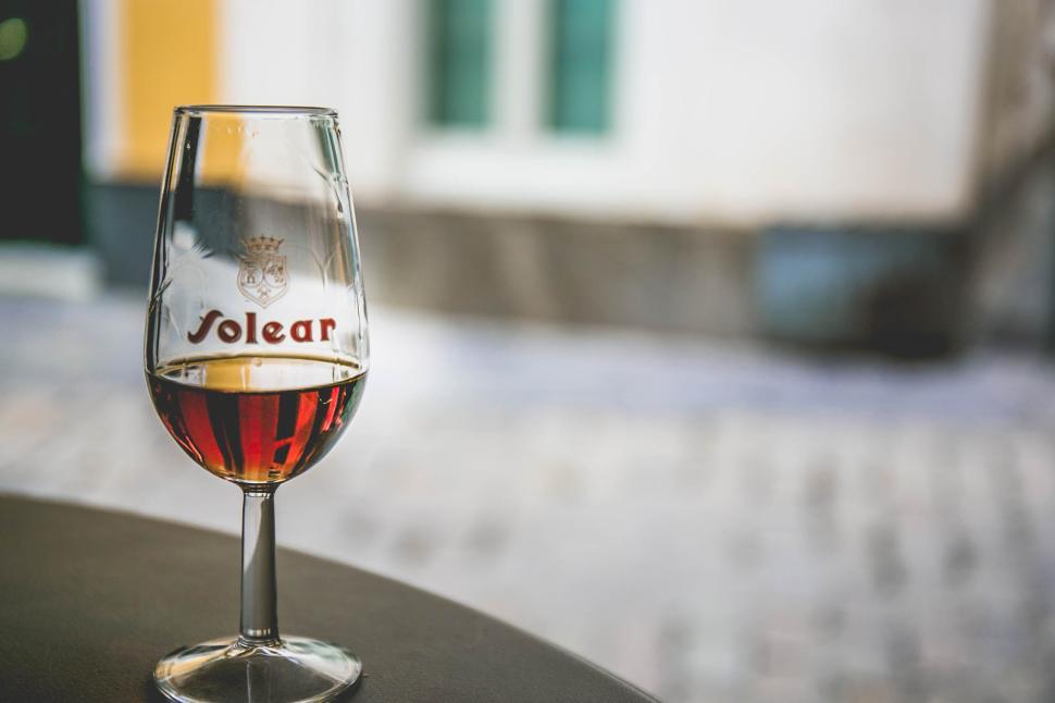 Free Image of Glass of Solear wine on outdoor cafe table 