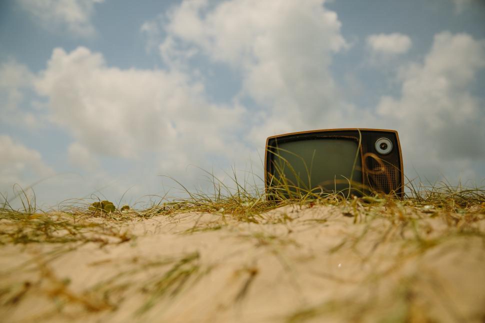 Free Image of Old television set abandoned on a sandy beach 