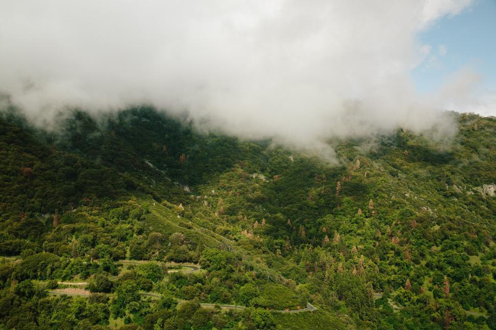 Free Image of Lush green mountains under a cloudy sky 