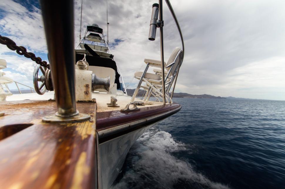 Free Image of Sailing boat on the calm sea under a cloudy sky 