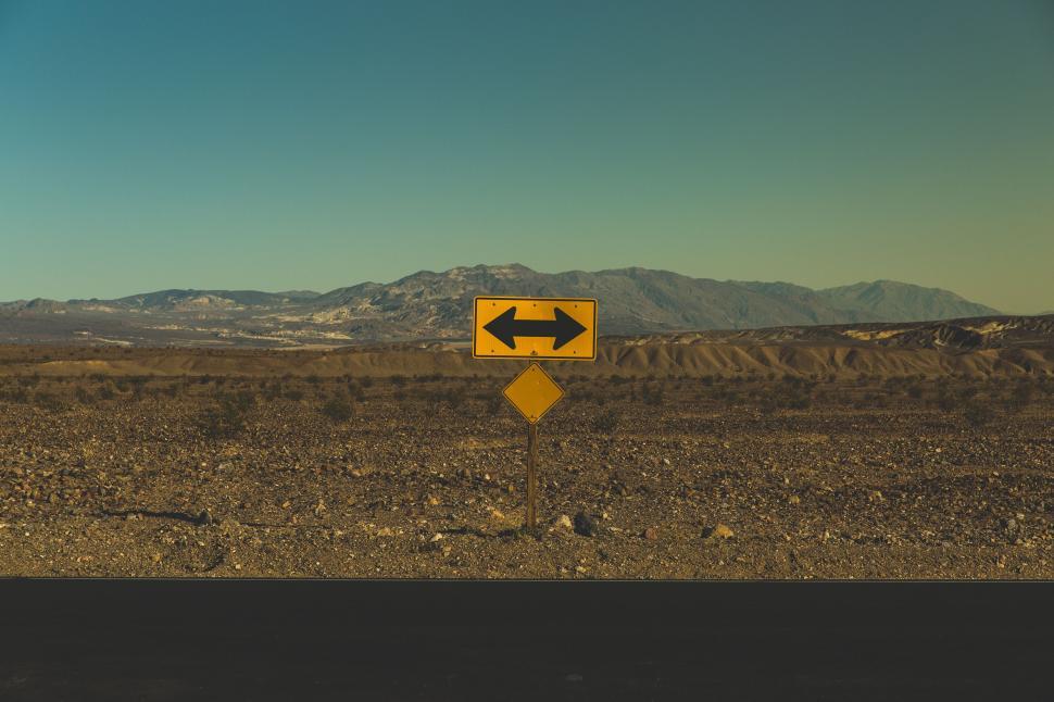 Free Image of Desolate road sign points both directions in a desert. 