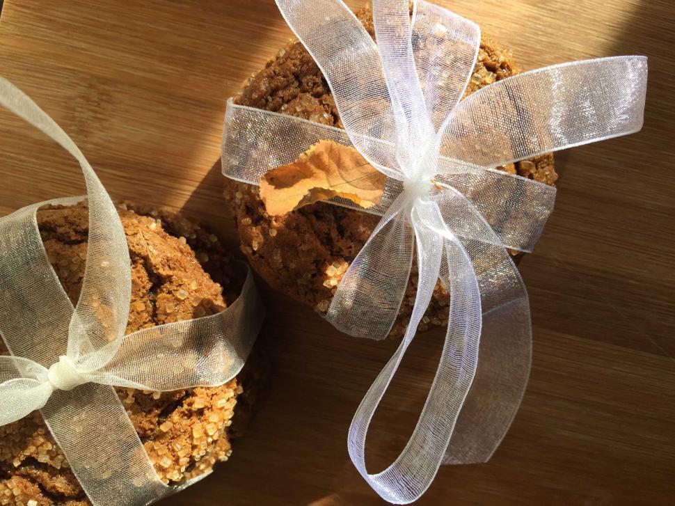 Free Image of Cookies wrapped in transparent ribbon on wooden surface. 