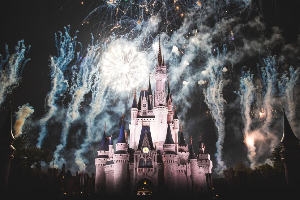 Free Image of Fireworks above a castle at night with crowds. 
