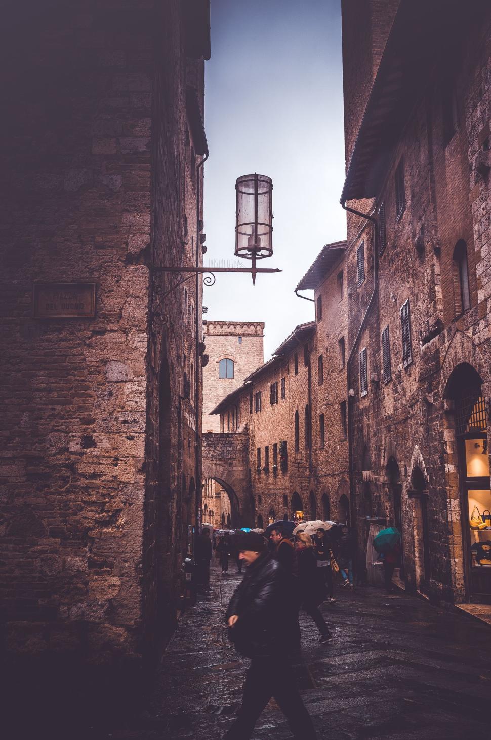 Free Image of Narrow cobblestone street in a historic European town. 