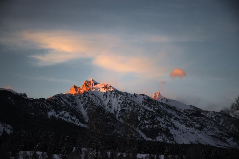 Free Image of Snow-capped mountain peak at dusk with glowing sky 