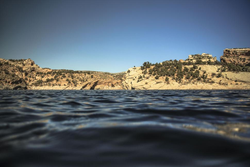 Free Image of Desert landscape with water under clear blue sky 