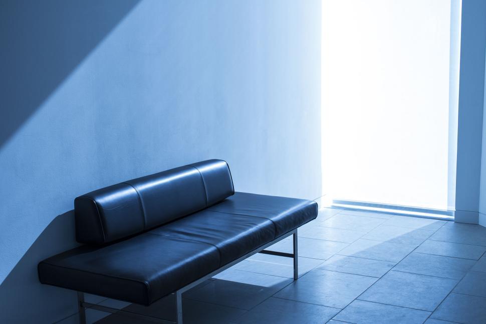 Free Image of Modern minimalist black bench in blue-lit interior space 