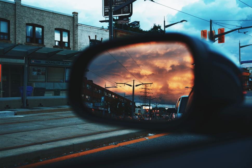 Free Image of Vibrant sunset view in car mirror reflecting street 
