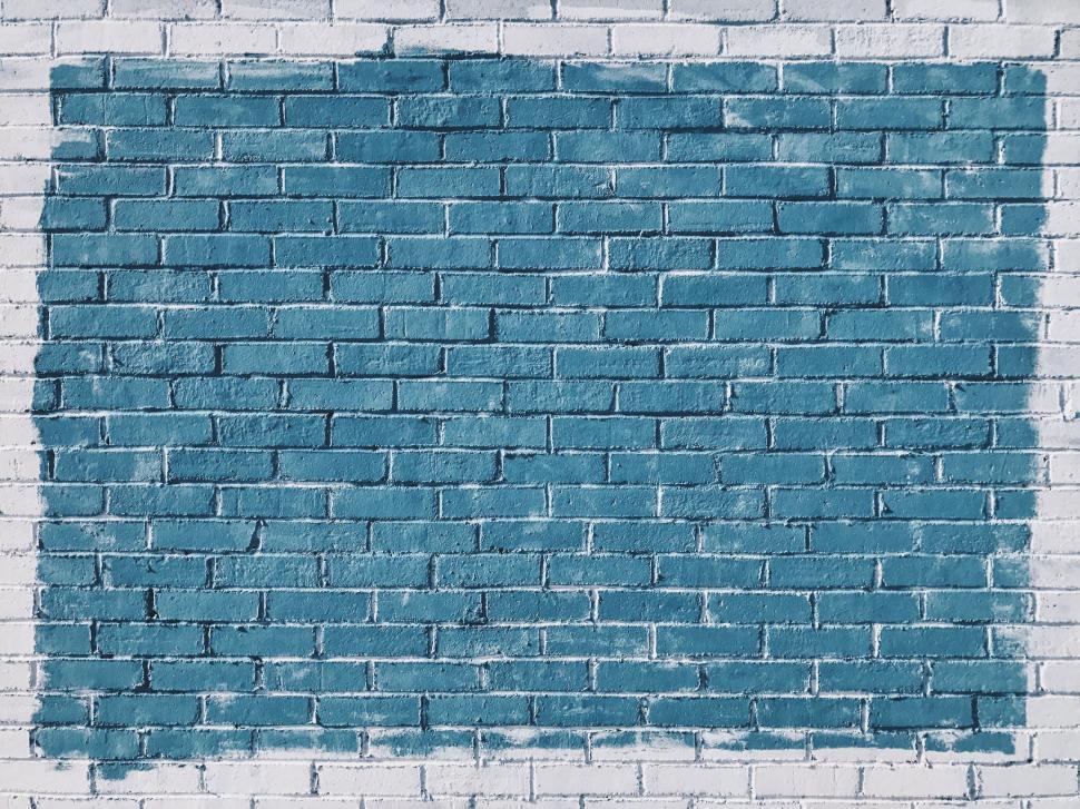 Free Image of Blue painted brick wall art installation with white background 
