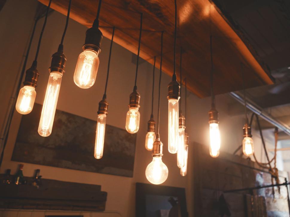 Free Image of Warm lit vintage light bulbs hanging indoors, cozy feel. 