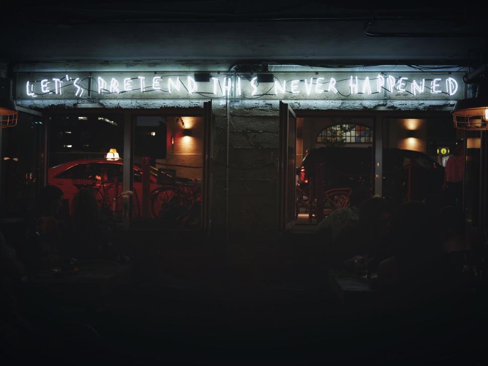 Free Image of Dimly lit interior with neon sign, cozy and intimate setting. 