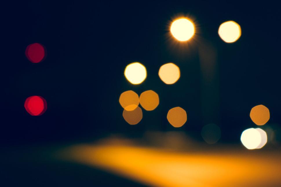 Free Image of Blurred city street lights at night with bokeh effect. 