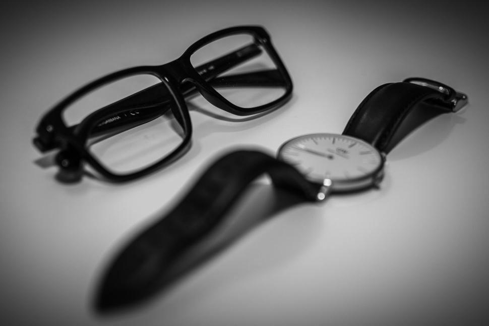 Free Image of Black eyeglasses and modern wristwatch on white backdrop 