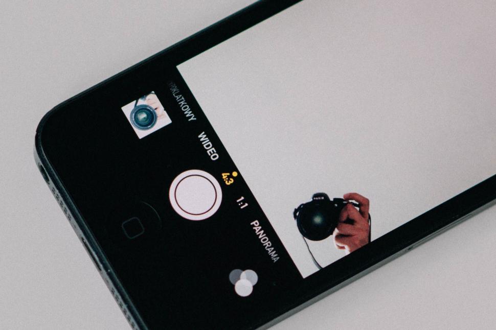Free Image of Smartphone capturing an image of a camera lens. 