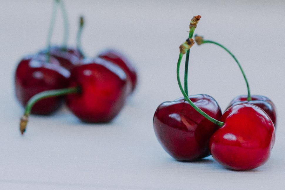 Free Image of Close-up of fresh cherries with stems on white background 