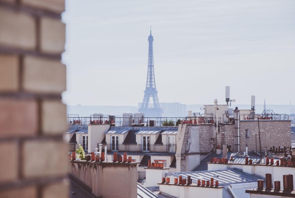 Free Image of Eiffel Tower view from Paris rooftops with soft focus 