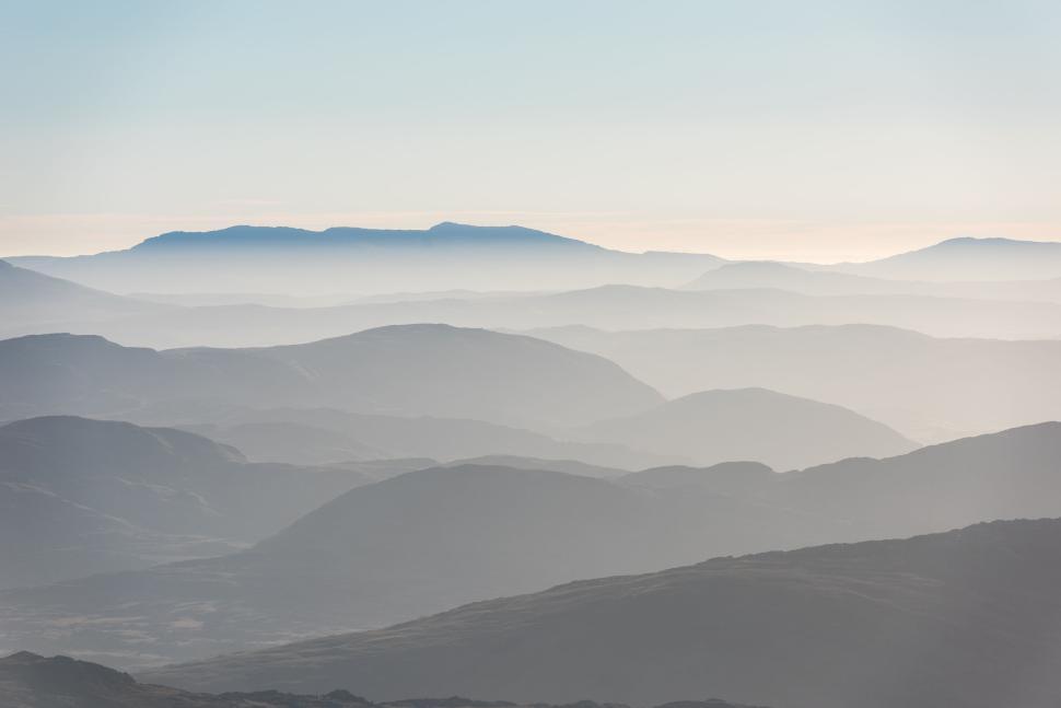 Free Image of Vast expanse of misty mountains under soft morning light 