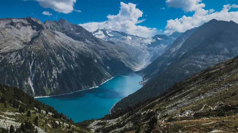 Free Image of Aerial view of deep blue lake surrounded by mountains 