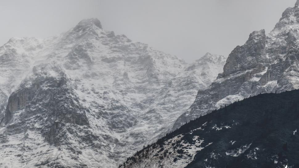 Free Image of Snow-capped peaks close-up, rugged winter terrain. 