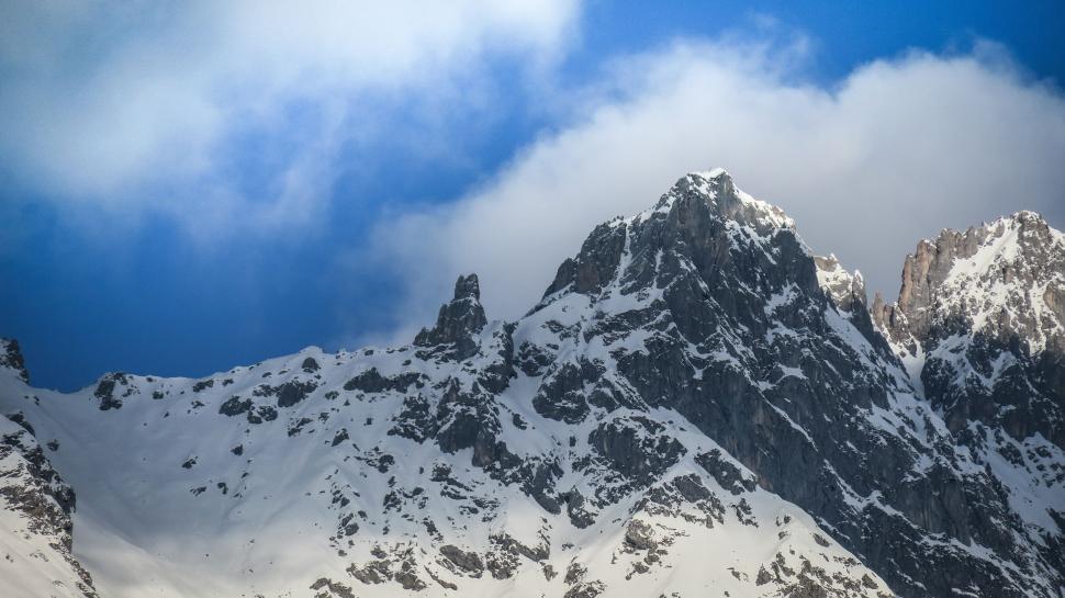 Free Image of Snowy mountain peak with blue sky, crisp and clear. 