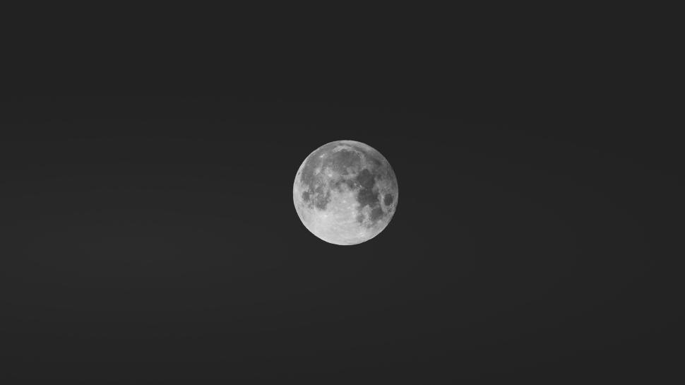Free Image of Full moon glowing brightly in the night sky alone. 