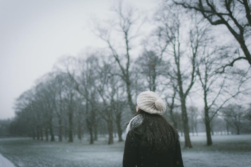 Free Image of Person standing in a snowy park during a winter day 