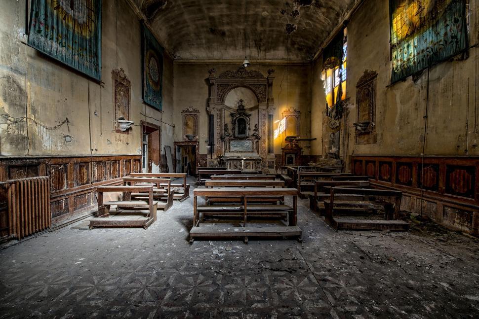 Free Image of Abandoned Church Interior Showing Aged Benches and Altar 
