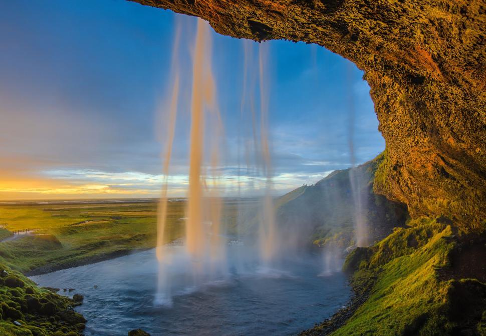 Free Image of Waterfall cascading from cave into tranquil pool below. 
