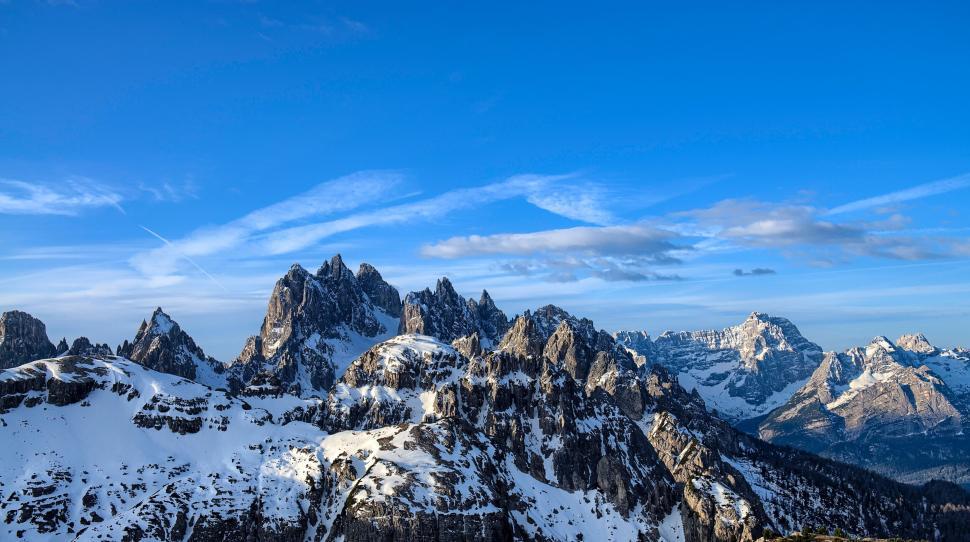 Free Image of Snow-capped jagged mountains under clear blue sky. 