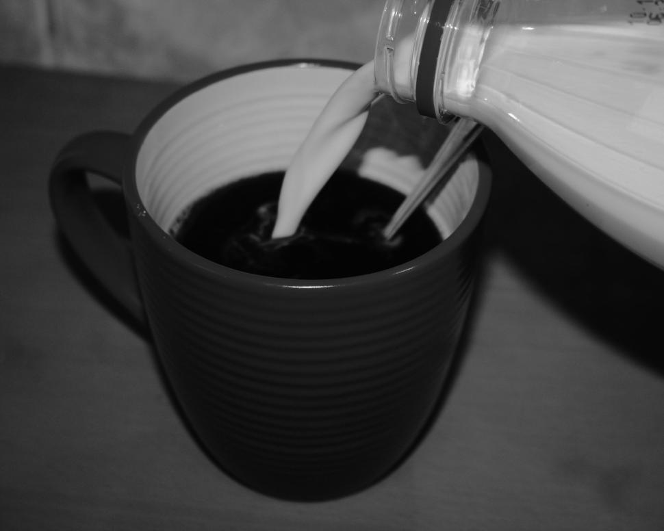 Free Image of Pouring milk into black coffee creating hypnotic swirls 