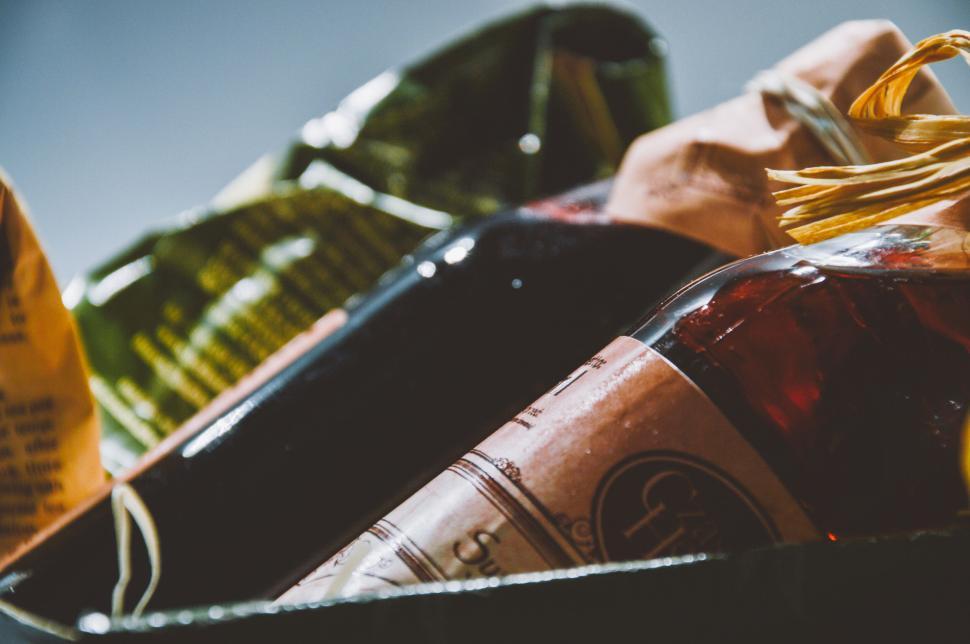 Free Image of Assorted wine bottles wrapped in colorful packaging. 