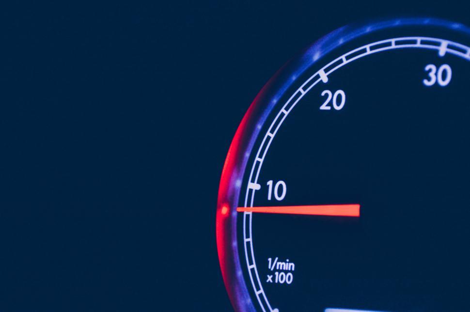 Free Image of Tachometer needle on ten against dark gradient background 